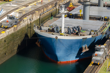 Fototapeta na wymiar Oil tanker, assisted by tugboats in Panama Canal