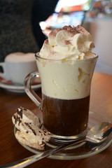 Delicious Viennese coffee in glass cup with whipped cream