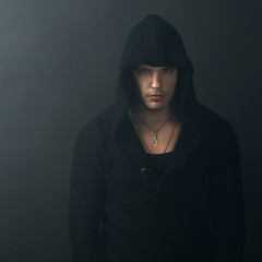 man in black hoodie looking confidently
