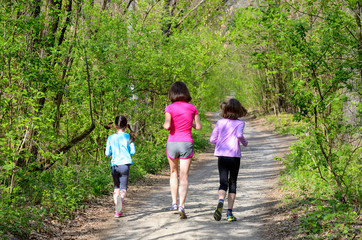 Family sport, happy active mother and kids jogging outdoors