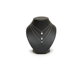 Diamond necklace on black mannequin isolated on white background