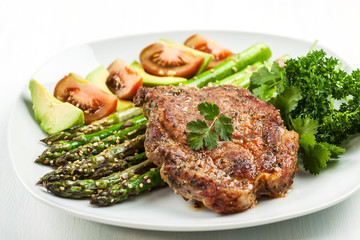 Glazed green asparagus with grilled pork chop