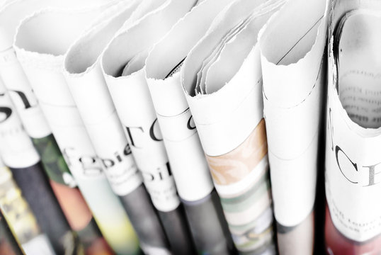 Folded newspapers standing