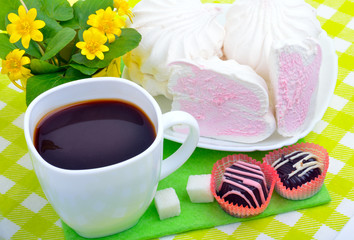 Cup of coffee with marshmallows and chocolate candies