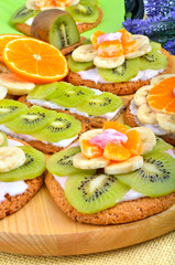 Fruit dessert with exotic fruits and lavender flowers