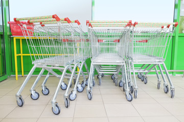 Shopping carts on car park near entrance of supermarket