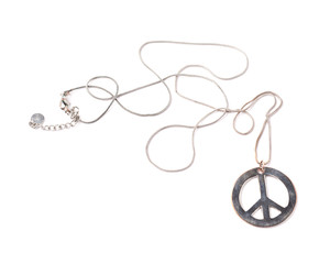Worn metal peace sign necklace isolated