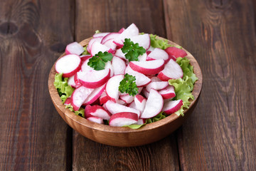 Radish salad on wooden table