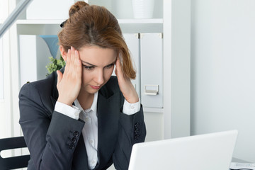 Young beautiful business woman trying to concentrate