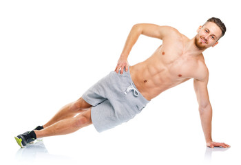 Sport attractive man doing fitness exercises on the white