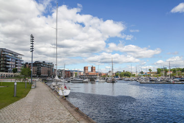Fototapeta na wymiar Boats and yachts on the harbor, Aker Brygge district, Oslo