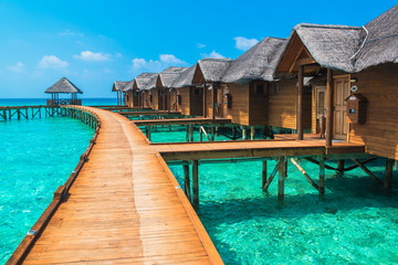 Over water bungalows with steps into amazing green lagoon - obrazy, fototapety, plakaty