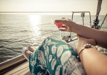 woman drinking cocktail on the boat