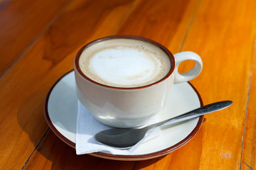 A Cup of coffee latte on wood table