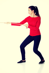 Young woman pulling a rope