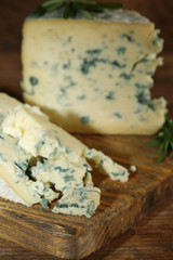 Blue cheese on wooden cutting board. closeup