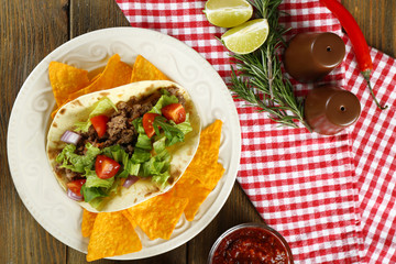 Mexican food Taco in plate on wooden table, top view