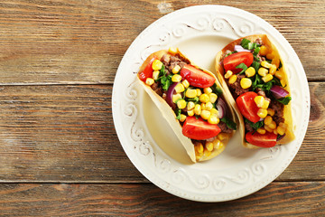 Mexican food Taco in plate on wooden table, top view