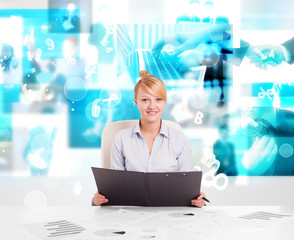 Business person at desk with modern tech images at background