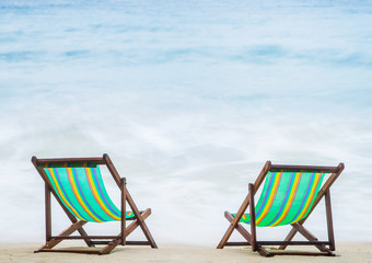 Lounge chairs on a tropical beach at summer