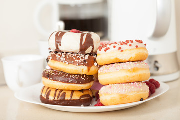 tasty donuts on  plate on  kitchen table.