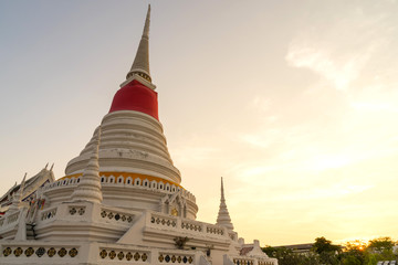 White pagoda in Wat Phra Samut Jedi under evening sky