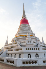 White pagoda in Wat Phra Samut Jedi under evening sky