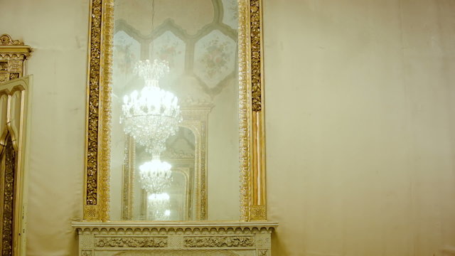 Beautiful hanging crystal chandelier reflection in mirror
