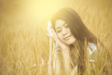 Attractive woman sitting on meadow alone