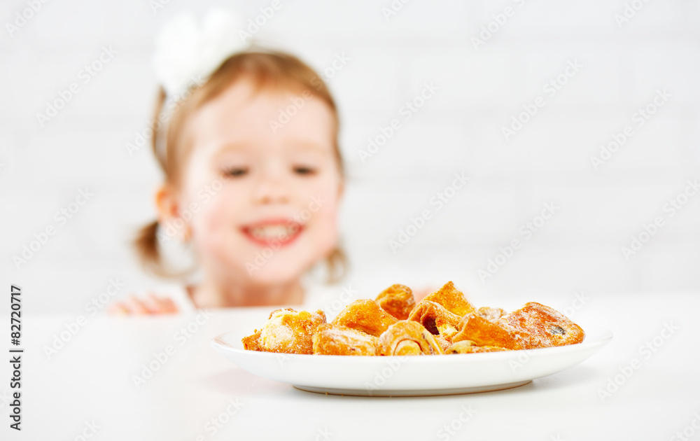 Wall mural happy child  girl eats biscuits, cookie