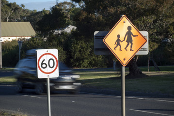 car speeding behind sixty speed limit sign