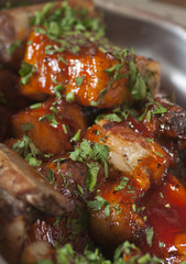 A delicious meal: lamb chops with tomato sauce.