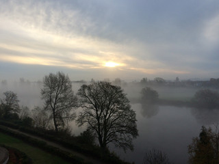 Sunrise through a foggy start of the day over the river Trent