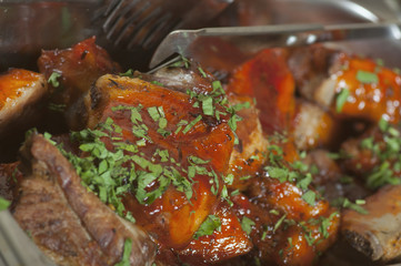 A delicious meal: lamb chops with tomato sauce and parsley.