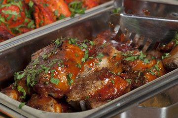 A delicious meal: lamb chops with tomato sauce and parsley.