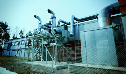 Industrial zone, Steel pipelines and valves against blue sky