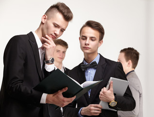 a group of young businessmen looking at paperwork