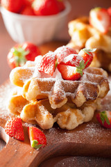 belgian waffles with icing sugar and strawberry