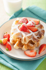 belgian waffles with icing sugar and strawberry