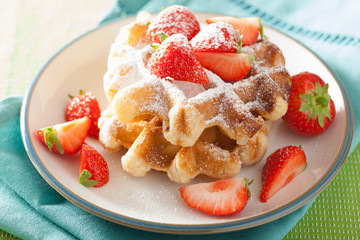 belgian waffles with icing sugar and strawberry
