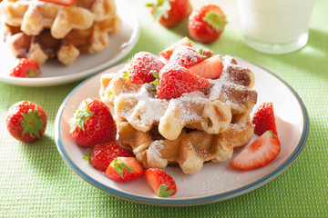 belgian waffles with icing sugar and strawberry