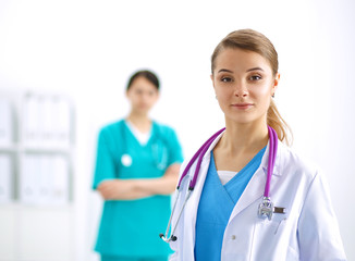 Fototapeta premium Woman doctor standing with stethoscope at hospital