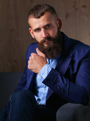 Fototapeta premium Businessman sitting on sofa in office lobby