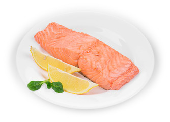 Fried salmon fillet on plate with lemon.
