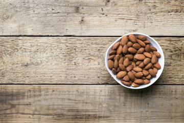 Almond nuts on wood background