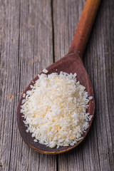 Old wooden spoon of desiccated coconut