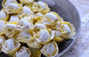 Preparing homemade tortellini.