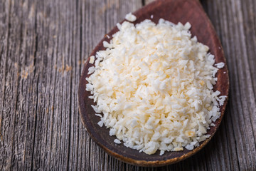Old wooden spoon of desiccated coconut