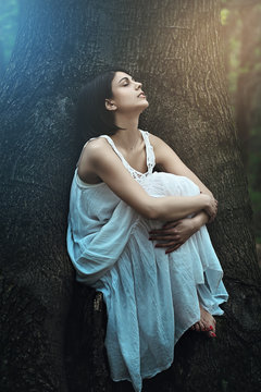 Beautiful Woman With Eyes Closed In A Dark Forest