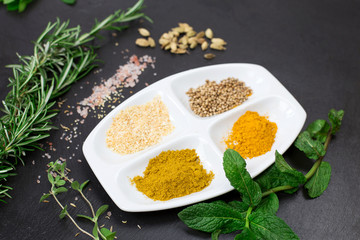 aromatic herbs and spices over slate sheet